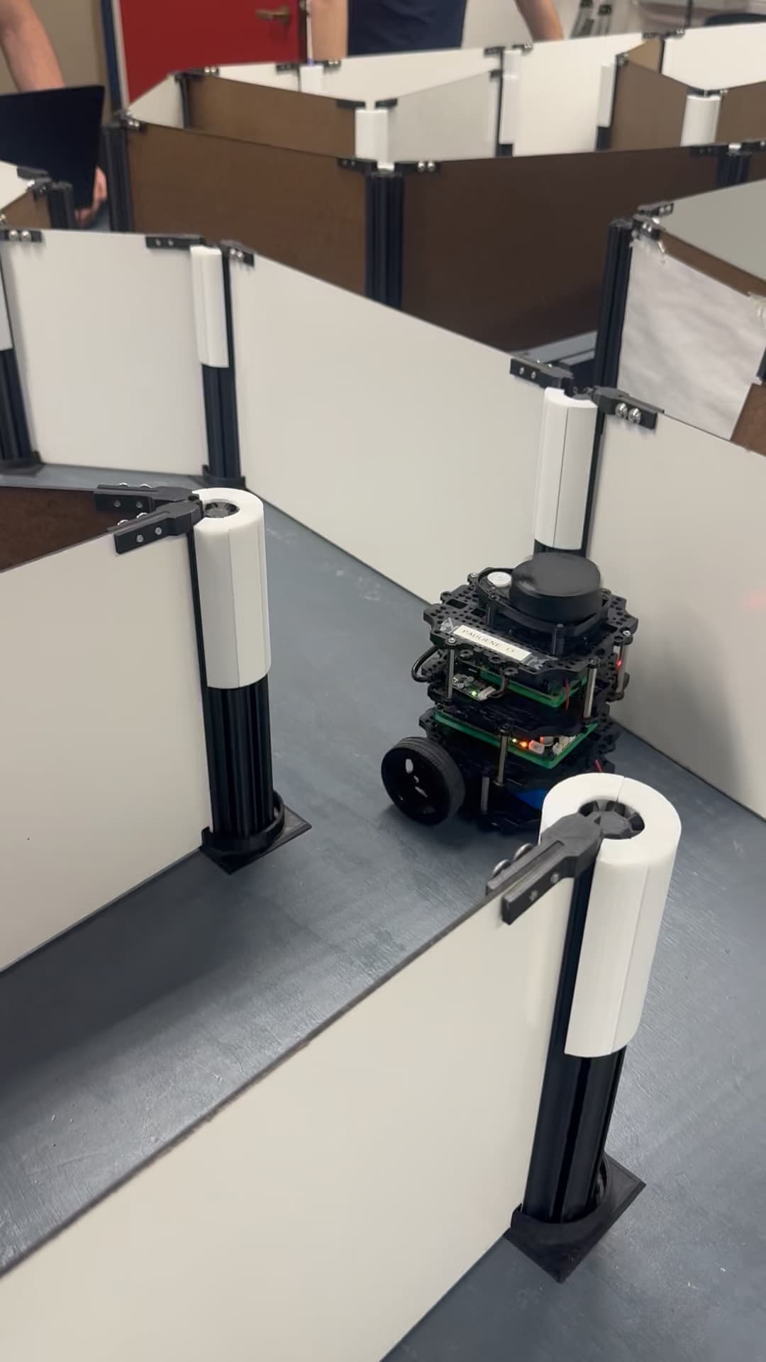 Maze exploring robot navigating between maze walls